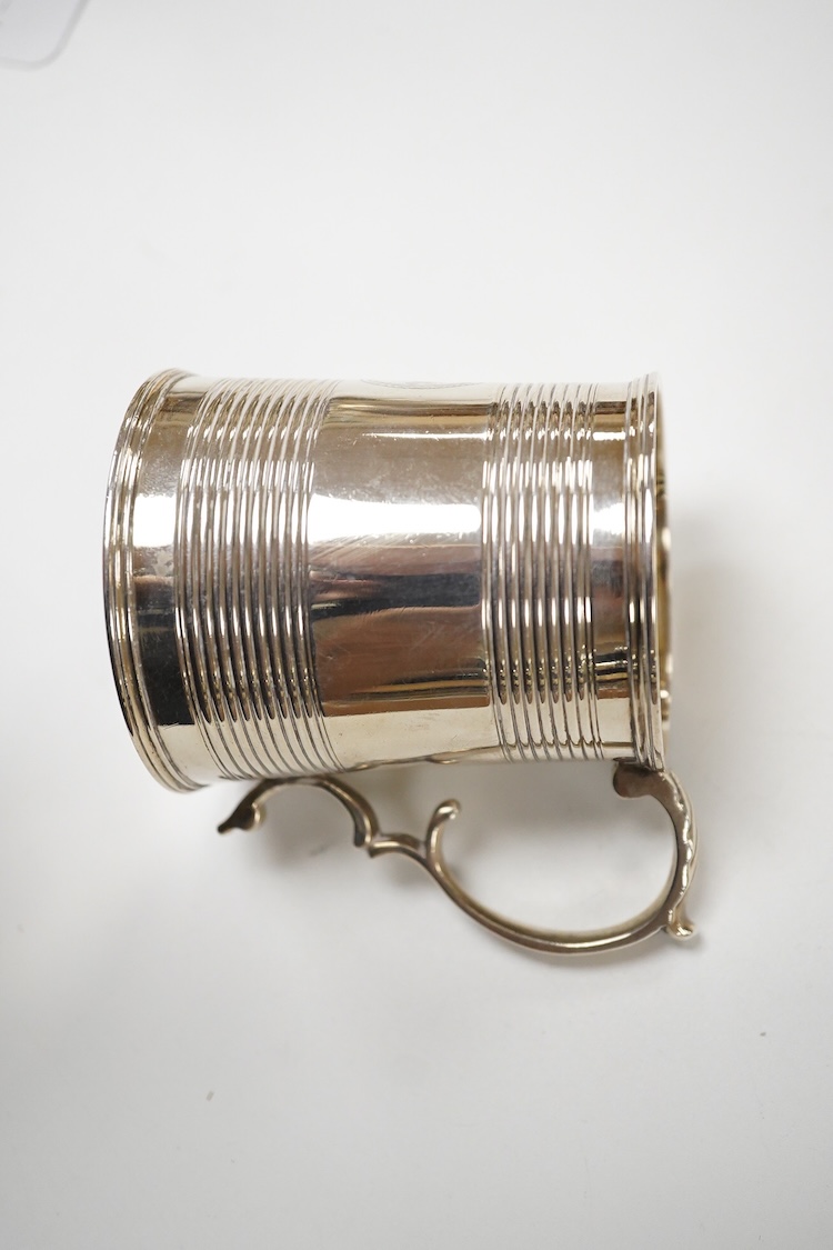 A William IV reeded silver christening mug, with later engraved initials and date to the base, Joseph Angell I & John Angell I, London, 1834, height 77mm, 3.9oz.